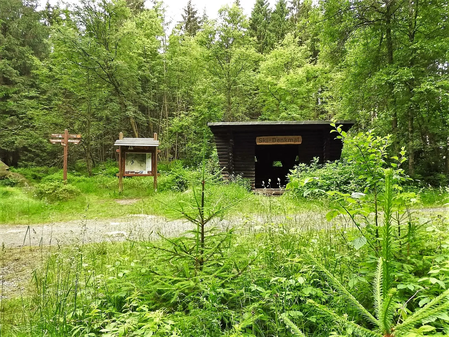 Forest hut at the ski monument with signposts
